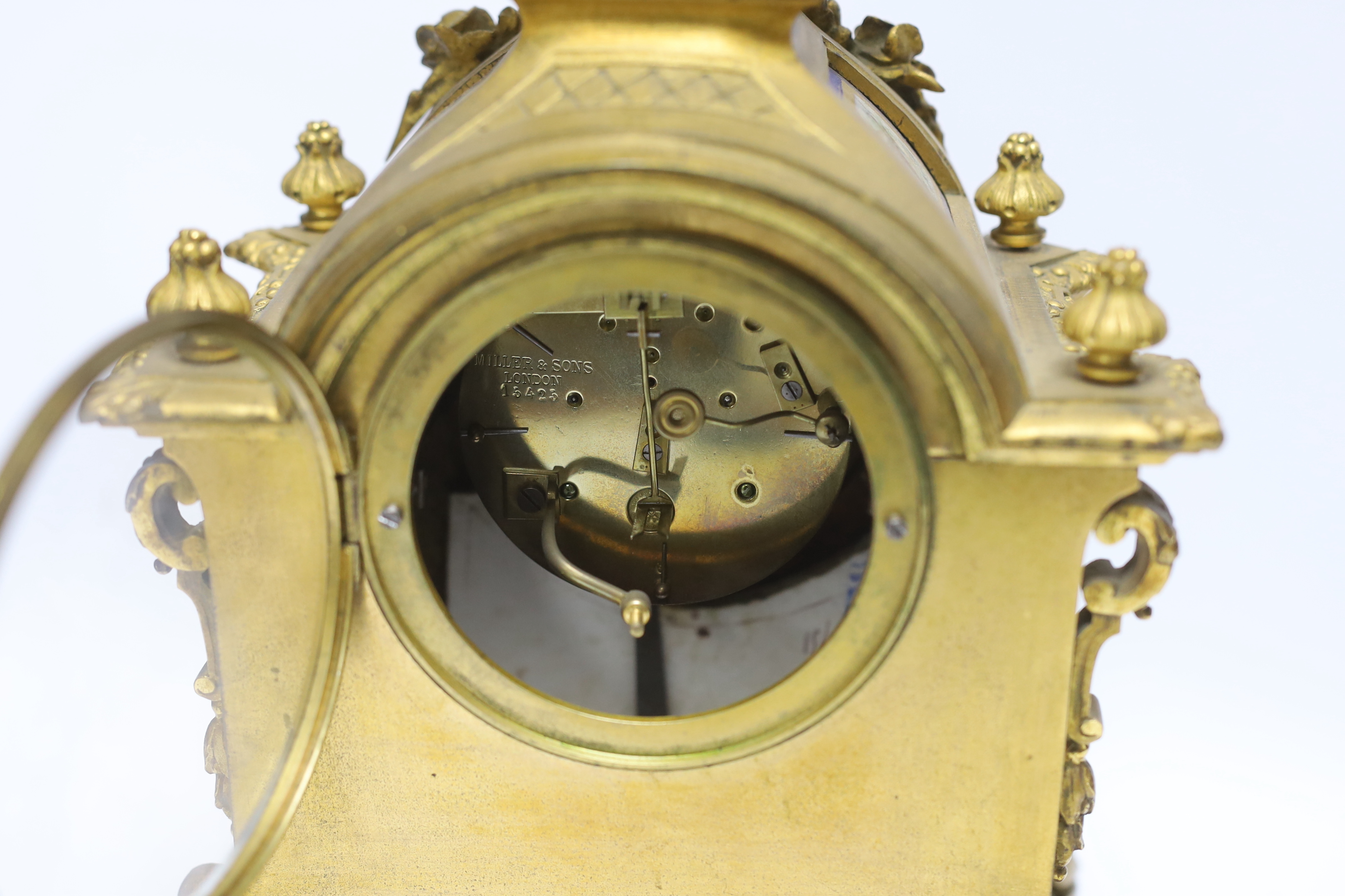 A Sevres style ormolu clock, Miller & Sons with two similar gilt spelter urns, pendulum no key, 44cm